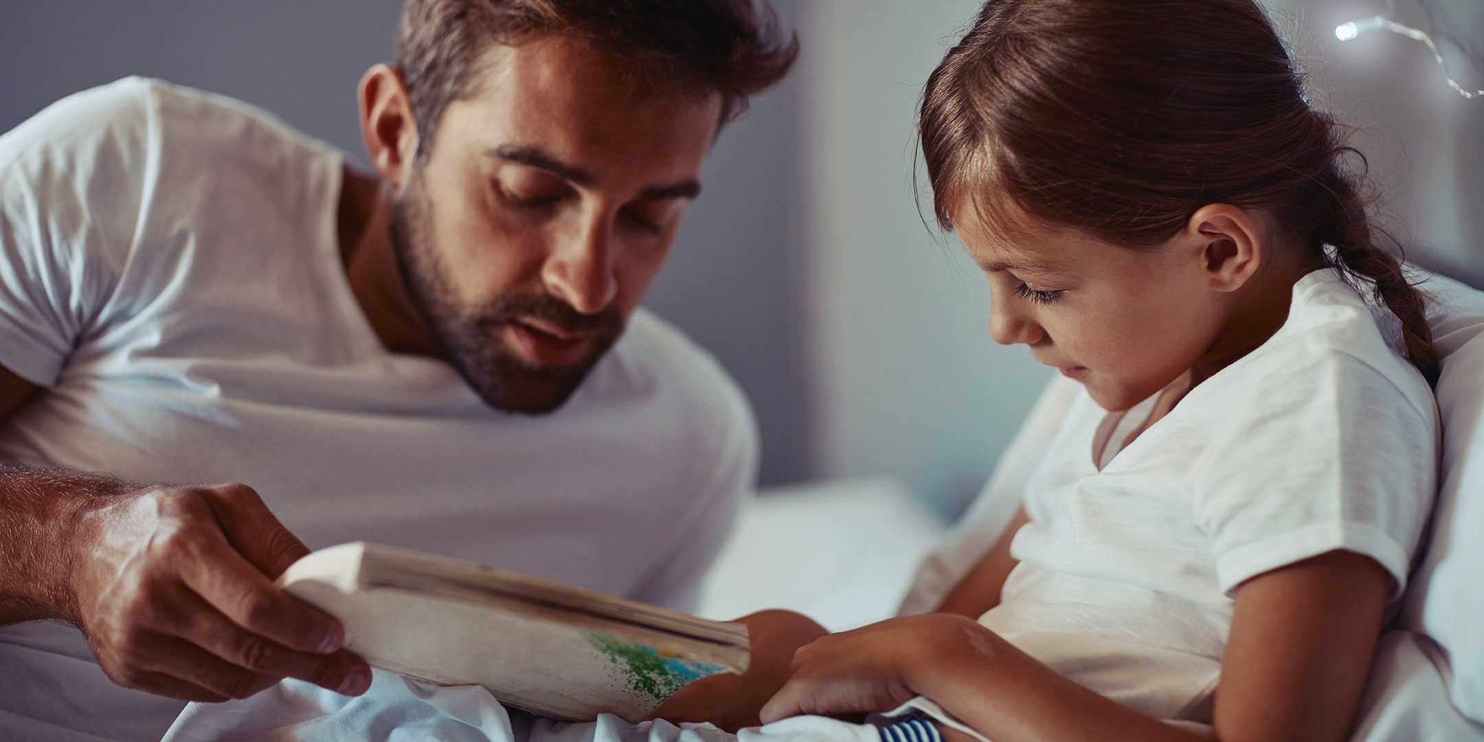 dad reading with daughter