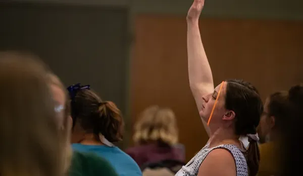 Woman with hand raised