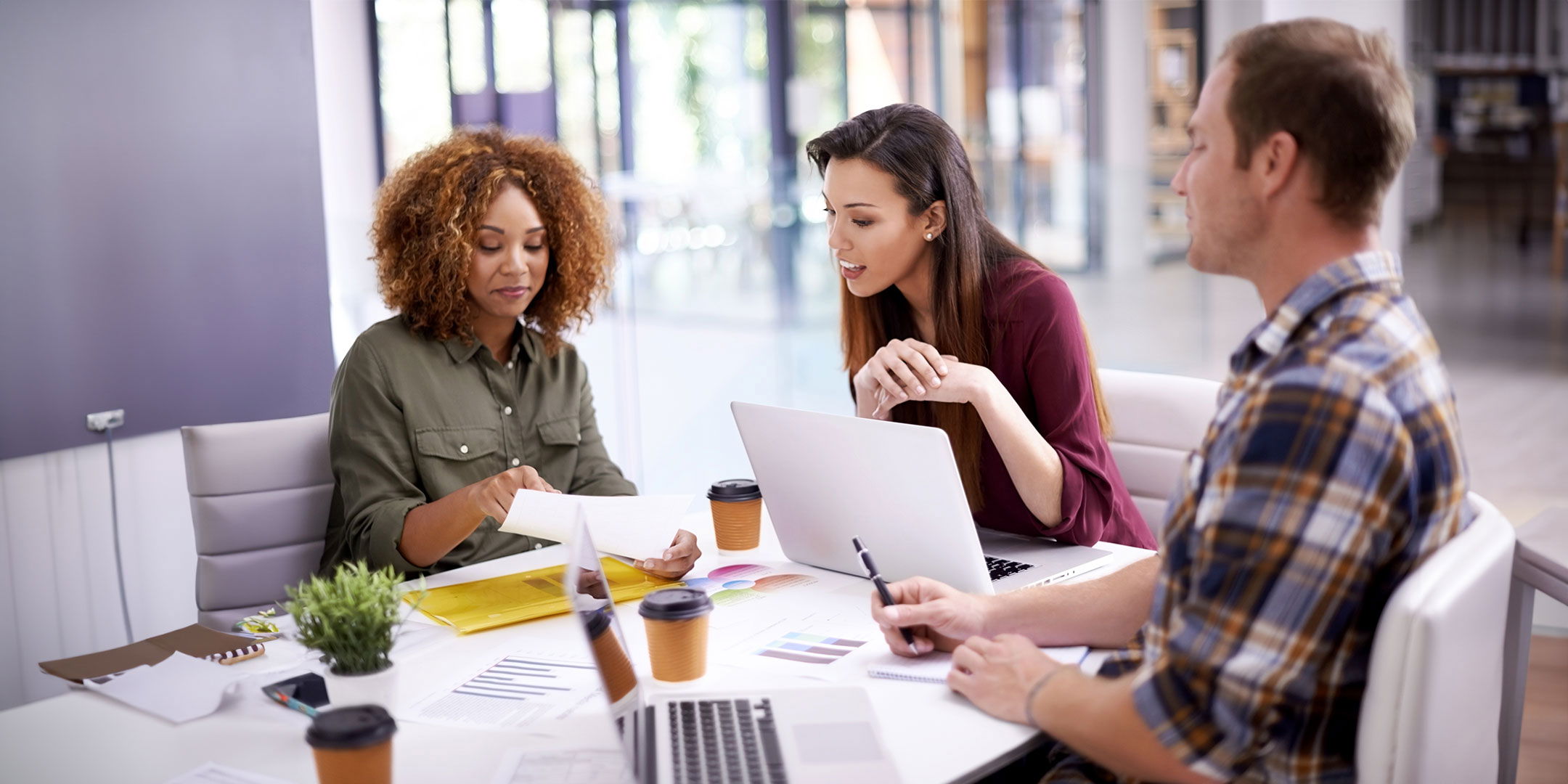 People talking around a computer