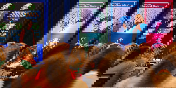 Becky on stage with banners